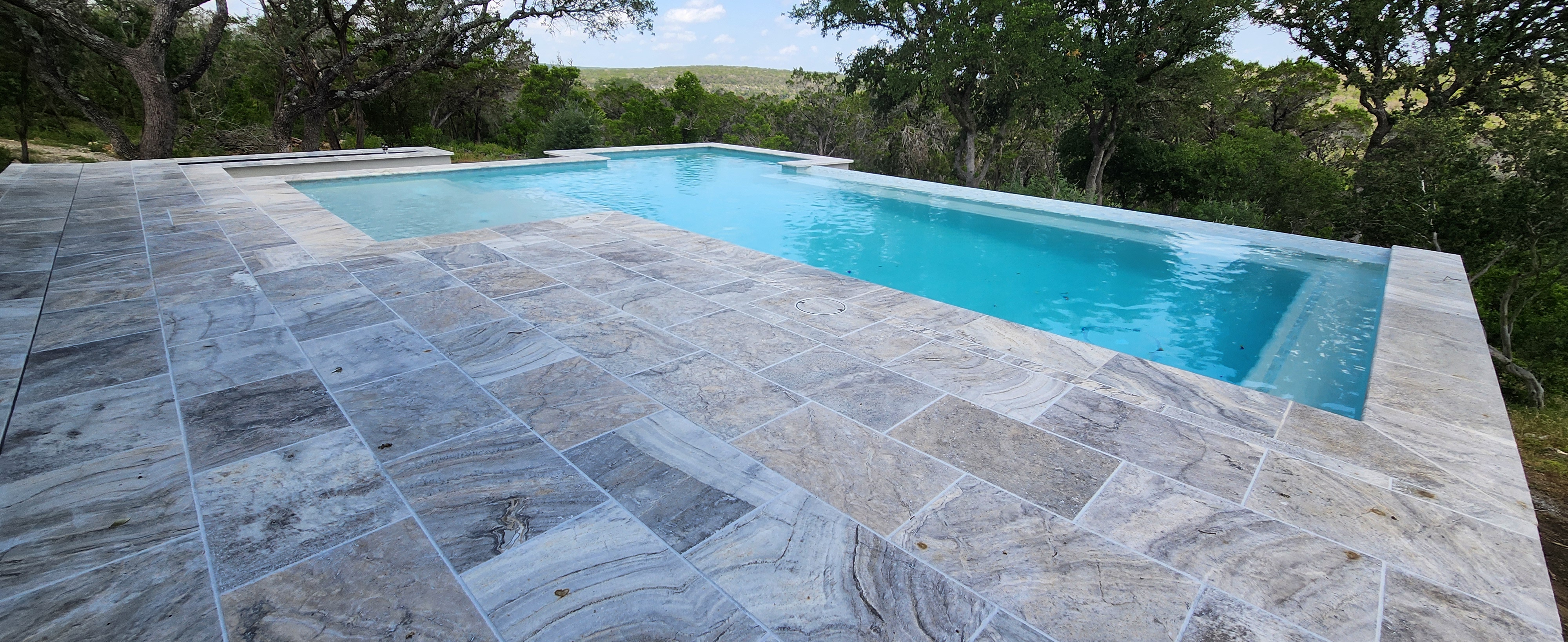 Luxury custom gunite pool with raised spa built by J. Oliver Pools in Bulverde, Texas