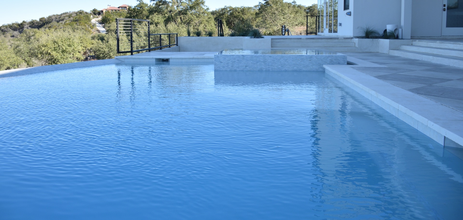 Custom gunite pool built by J. Oliver Pools, backed by a workmanship warranty